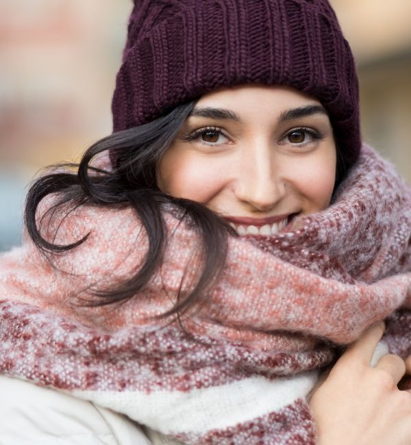 woman holding a scarf in winter
