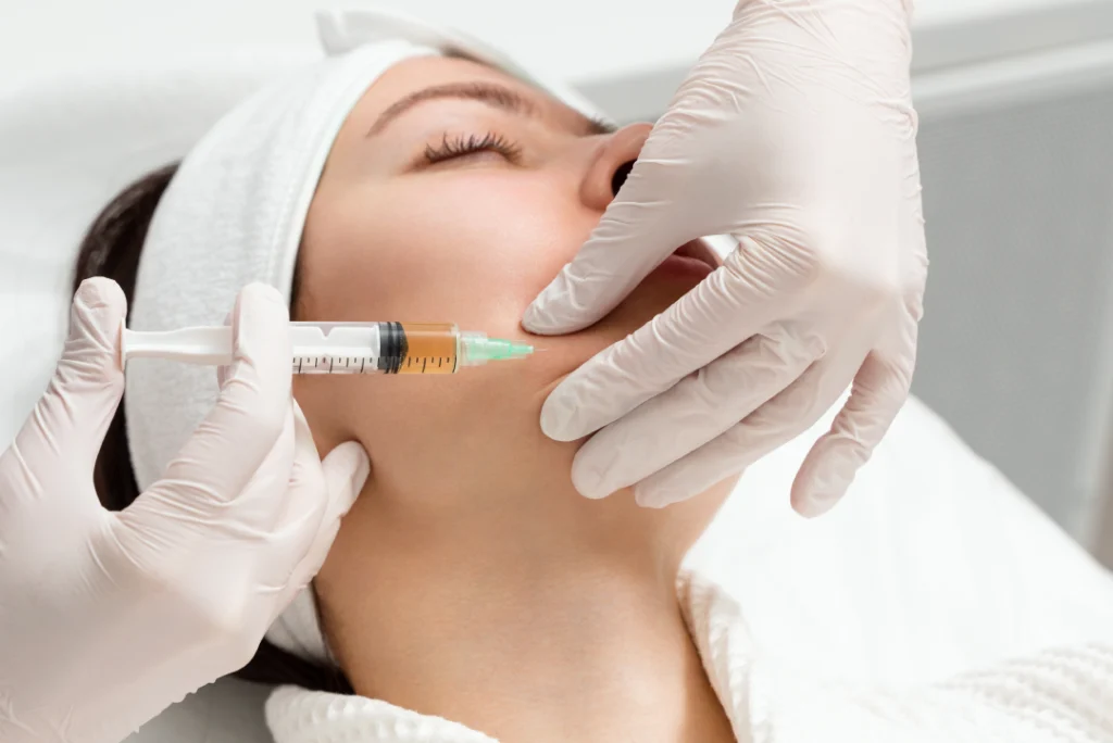 A professional administering dermal fillers with precision during a cosmetic treatment session.