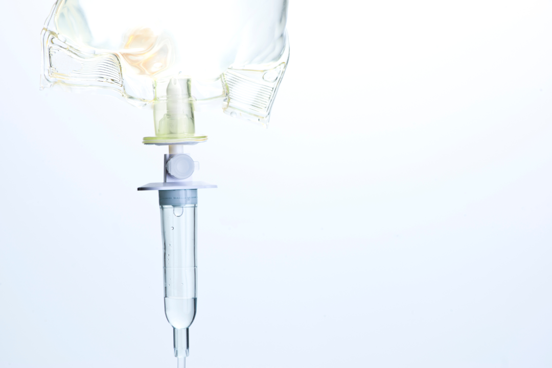 A close-up of an IV drip delivering fluids for therapy.