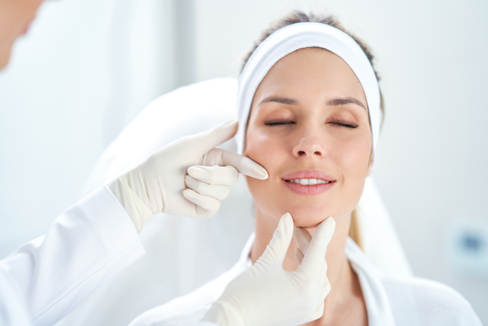 A woman smiling during a medspa injectables consultation.