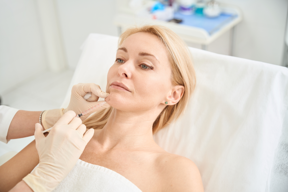 Woman receiving wrinkle reducers injection at a med spa.