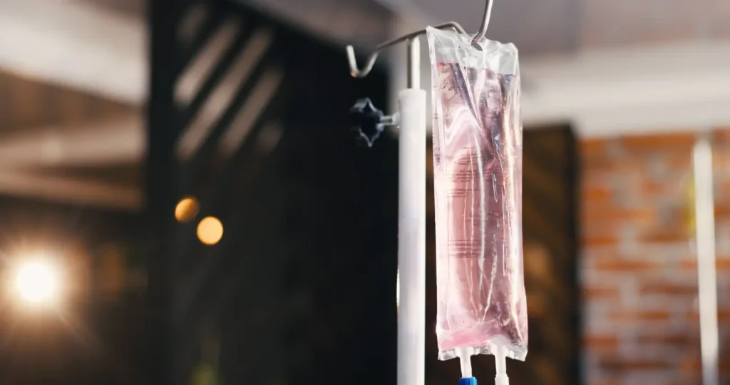 IV hydration fluid bag hanging from a medical stand.